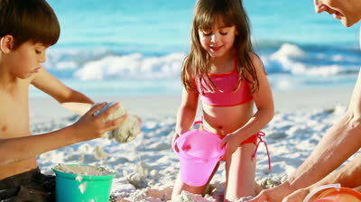 stock-footage-father-and-his-children-building-sand-castles-on-the-beach